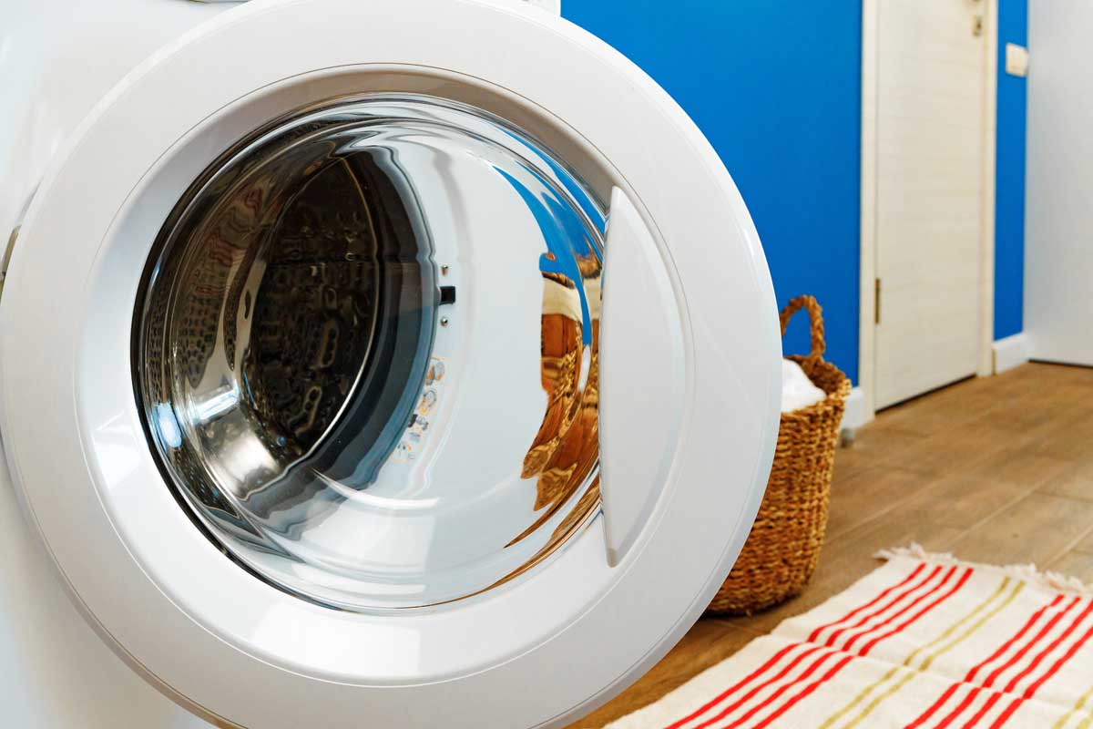 15 Household Appliances to Unplug During a Heatwave to Avoid Overheating & Surges - un 41456900 close up of washing machine in bathroom