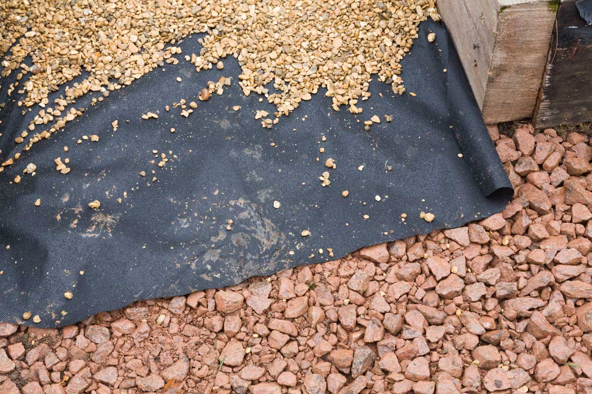 weed barrier fabric on crushed stone for pea gravel patio