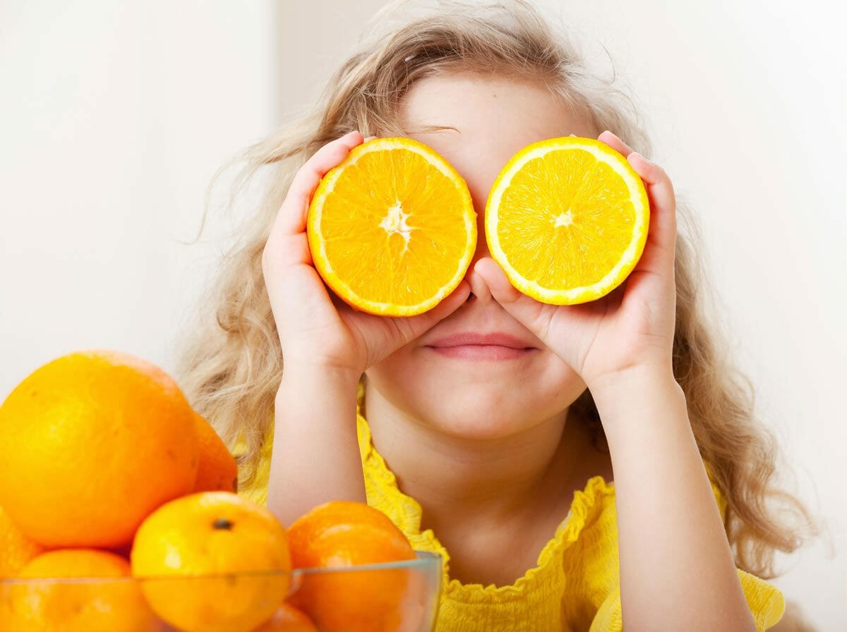 a child with oranges.