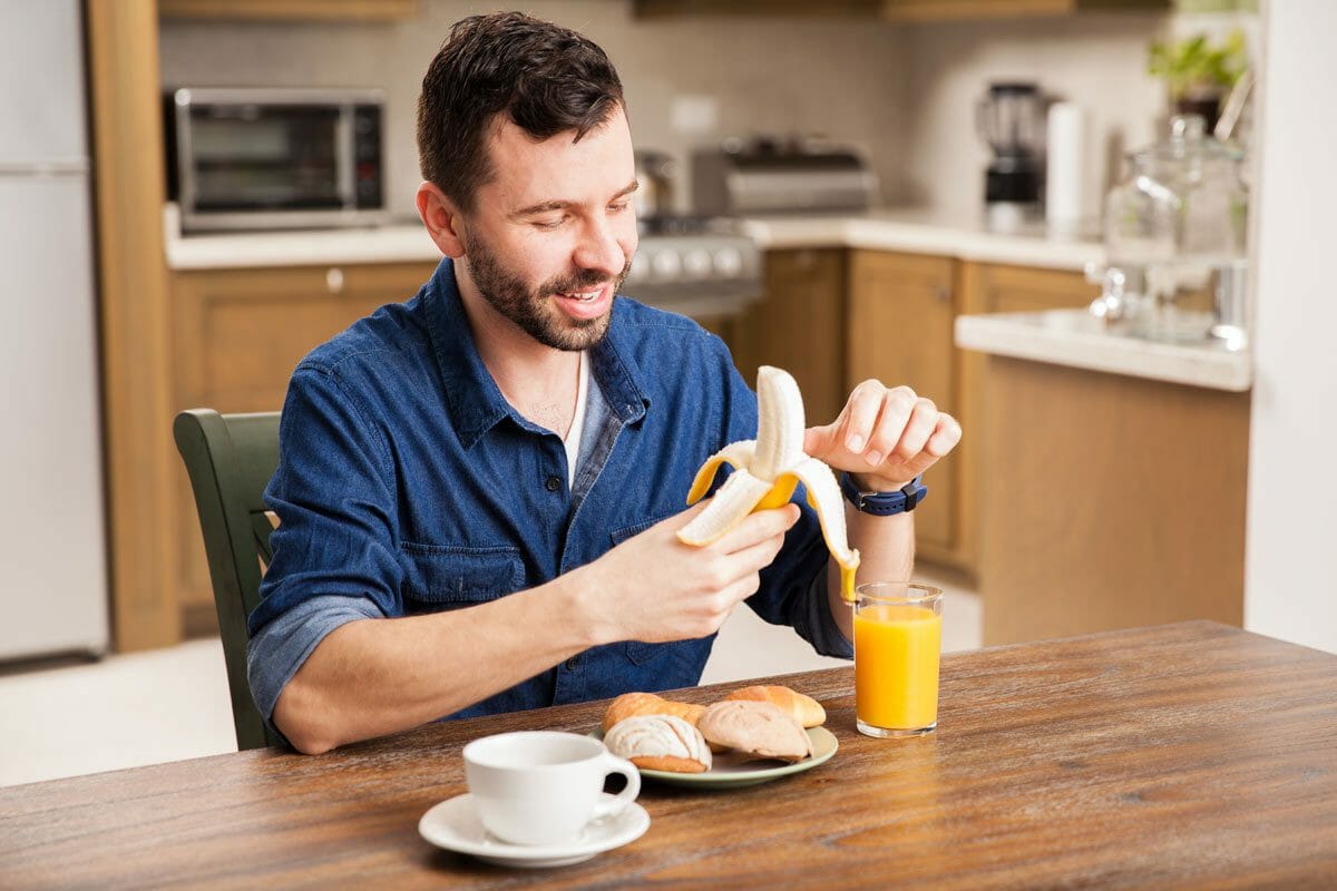 man peeling a banana 