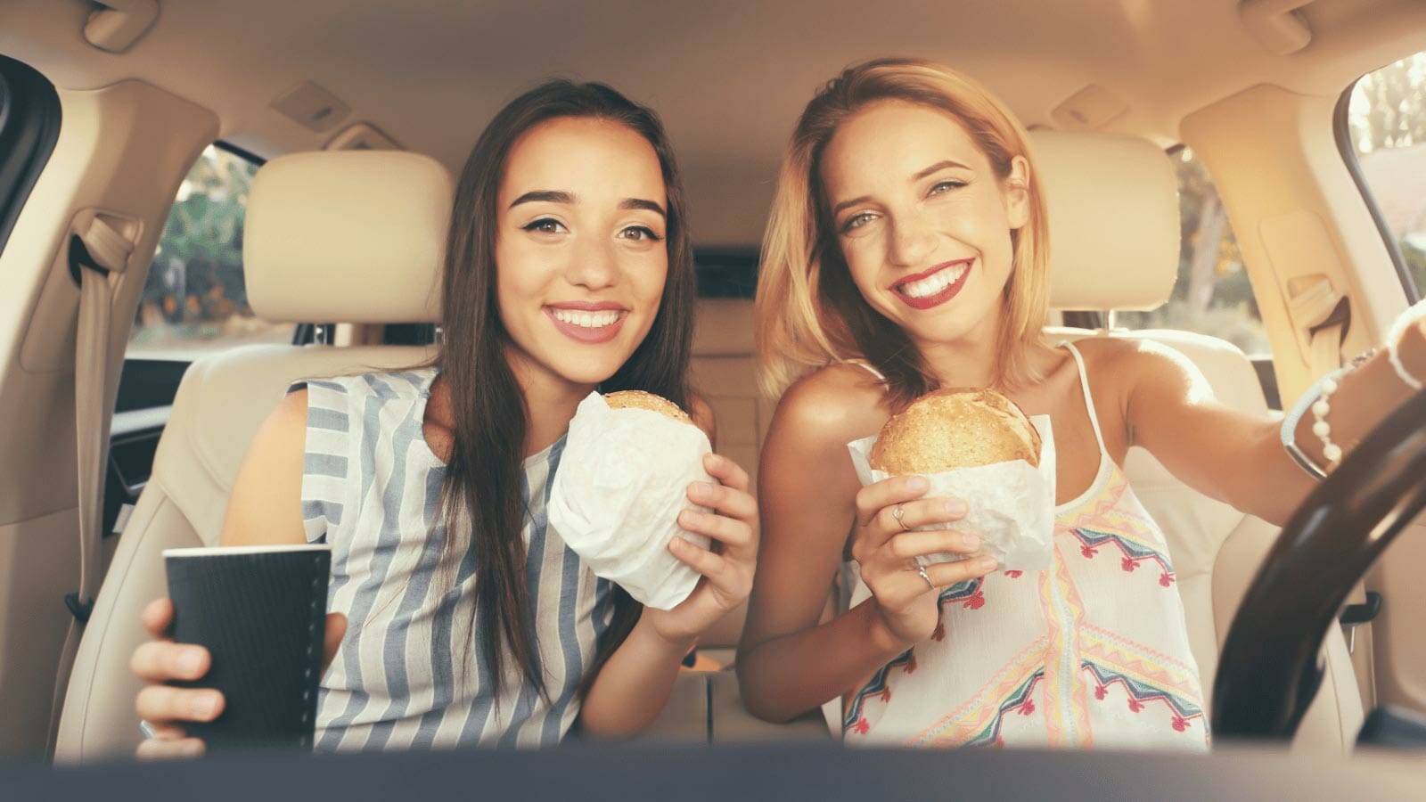 women in car eating