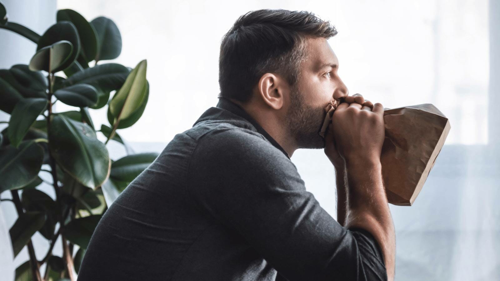frustrated man with houseplant
