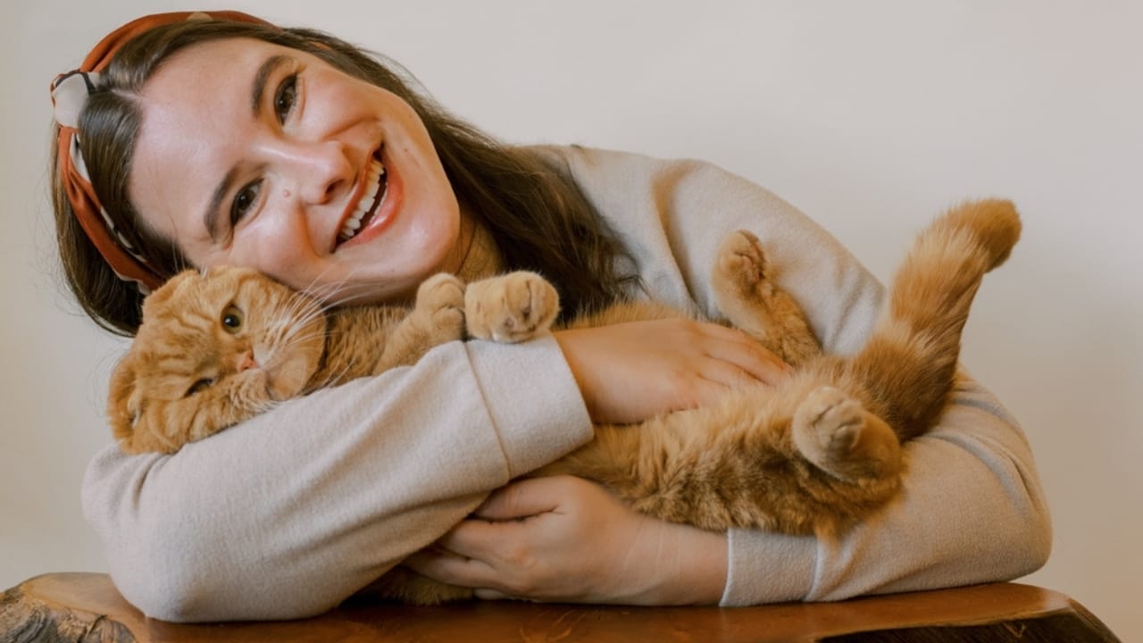 9 Lives, 9 Health Benefits: How Cats Can Extend Your Lifespan - woman hugging cat baby ss2399908173