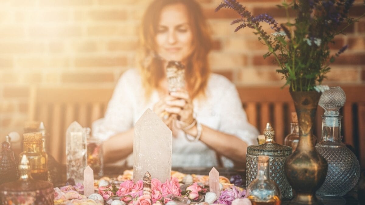 Are You a Magnet for Negativity? Use These 8 Crystals to Help Ward off Bad Vibes - woman with crystal smiling ss2185874551