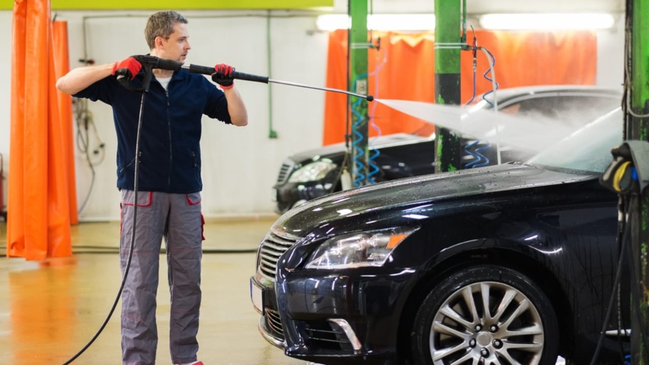 Automatic Car Washes May Be Costing You More Than You Think - Man worker car wash dp57138837