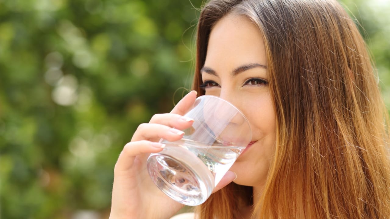Sun Water: The Forgotten Elixir to Naturally Boost Your Health - woman drinking water dp48959805