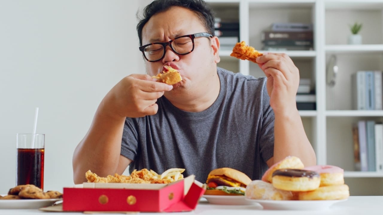 15 Foods You Can’t Resist – And Science Knows Why - Fat man enjoy eating junk food ss2213279091