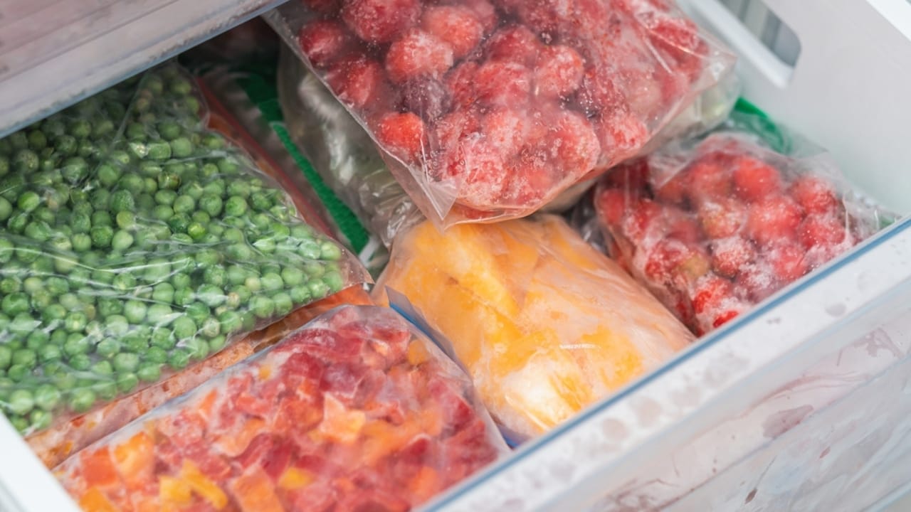 18 Foods to Stock in a Survival Pantry for 20+ Years - bags with frozen vegetables in refrigerator ss2080084744