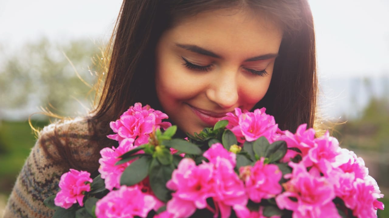 15 Fragrant Plants to Keep Your Garden Blooming from Spring to Fall - woman smelling flower ss190921283