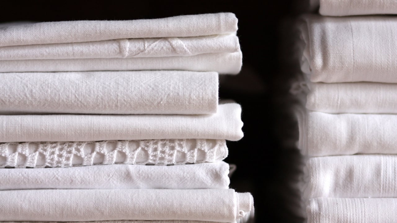 Quality Over Quantity: 20 Home Essentials You Should Never Scrimp On - pile of bed sheets dp26331461