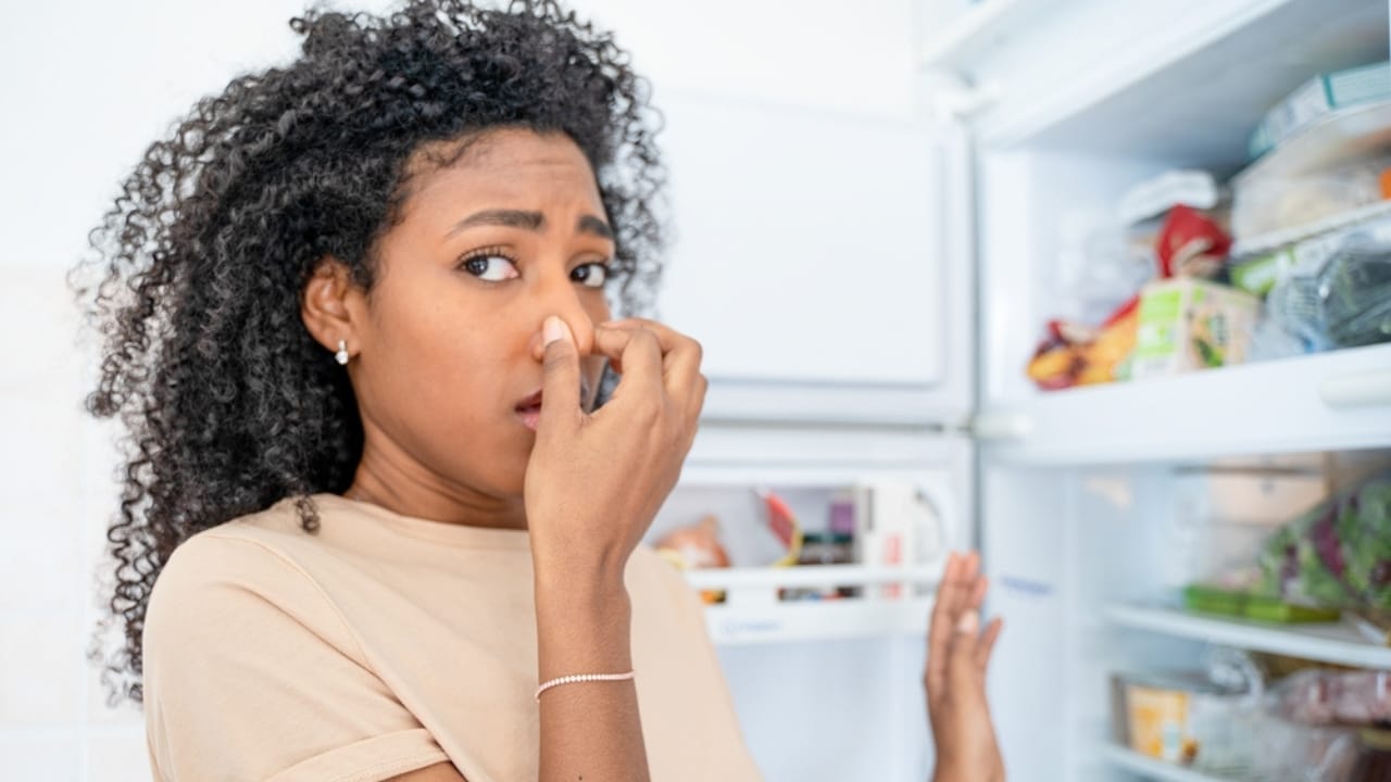 15 Foods in Your Fridge That Spoil Faster Than You Think - woman stinky smell ss2144702999