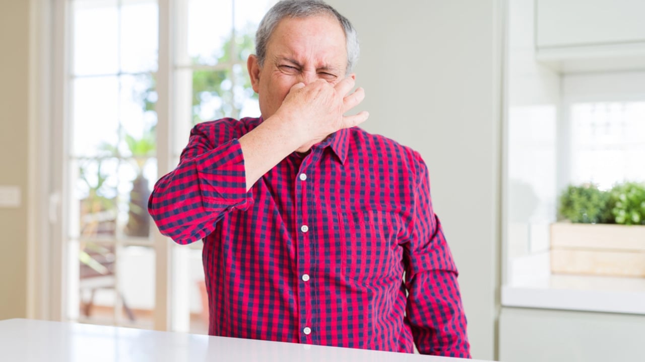 8 Easy Ways to Get Rid of That Musty "Old House" Smell - old man covering nose smelly inside house dp263912116 dnoh
